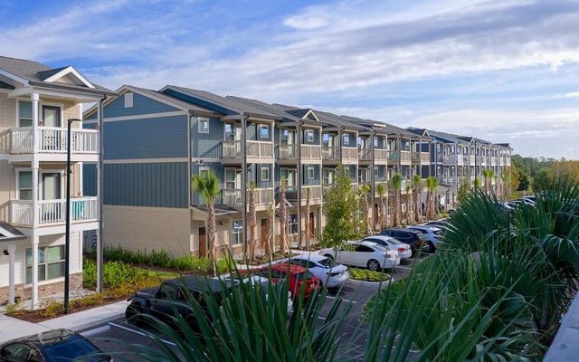 Apartment building with balconies and parking exterior at The Retreat East in Orlando Student Accommodation