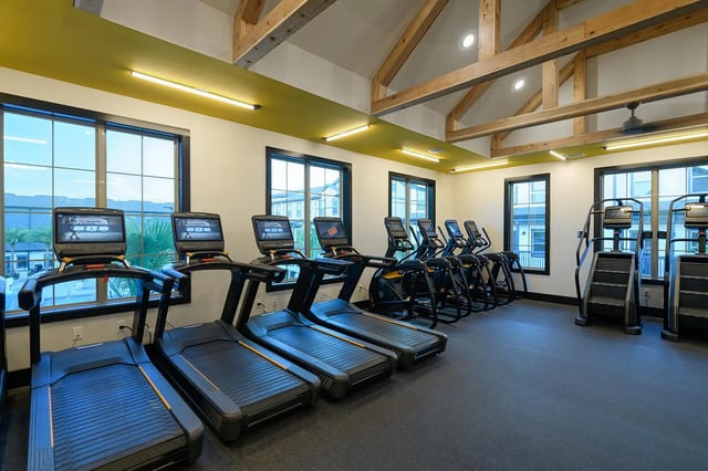 Treadmills ellipticals stair climbers gym fitness room at The Retreat East in Orlando Student Accommodation