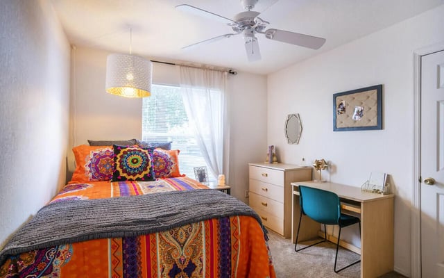 Bed dresser desk and chair Bedroom at Pointe at Central in Orlando Student Accommodation
