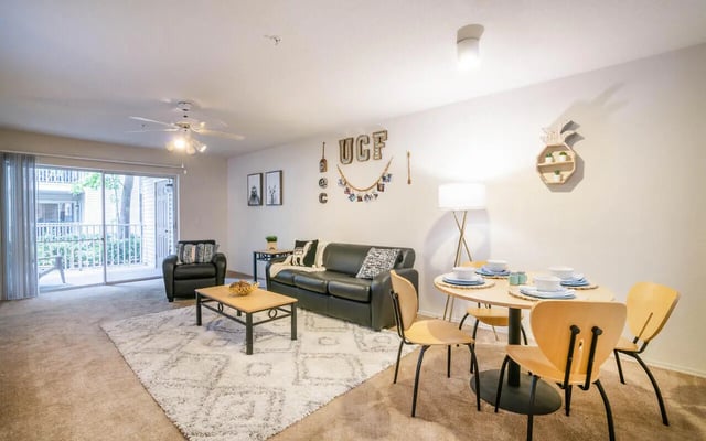 Sofa coffee table chairs and dining table living room at Pointe at Central in Orlando Student Accommodation
