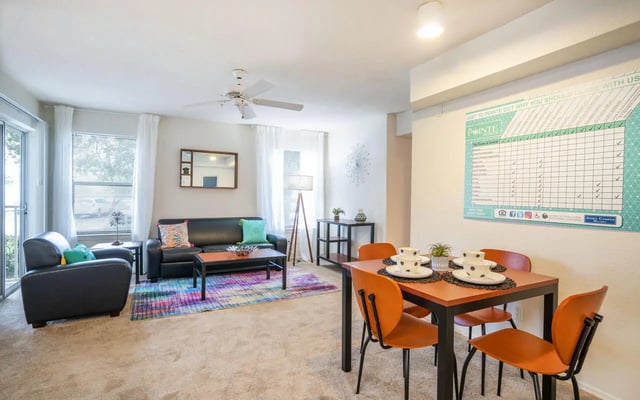 Sofa chairs dining table set living room at Pointe at Central in Orlando Student Accommodation