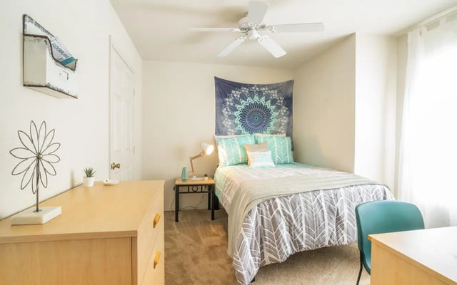 Bed with mandala tapestry and desk bedroom at Pointe at Central in Orlando Student Accommodation