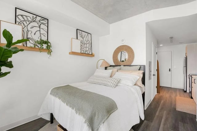 Bed with white linens artwork and mirror bedroom at Terrazul in Miami Student Accommodation