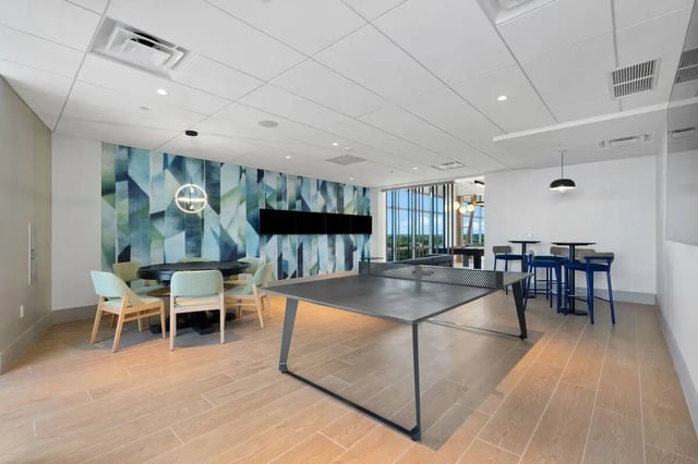 Ping pong table chairs table and high stools recreation area at Terrazul in Miami Student Accommodation