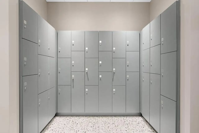 Rows of gray lockers with numbered doors Locker room at Terrazul in Miami Student Accommodation
