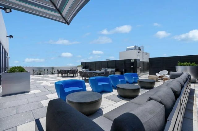 Rooftop lounge chairs tables seating area exterior at Terrazul in Miami Student Accommodation