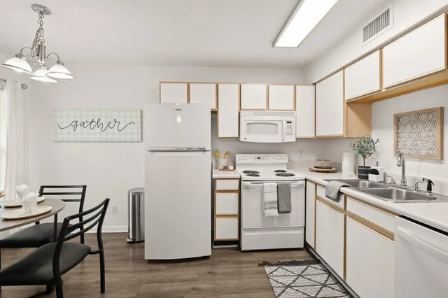 White kitchen with refrigerator stove microwave sink kitchen at Villa Reanna in Tallahassee Student Accommodation