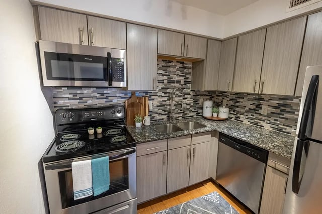 Microwave stove sink cabinets dishwasher kitchen at Vertex Tallahassee in Tallahassee Student Accommodation