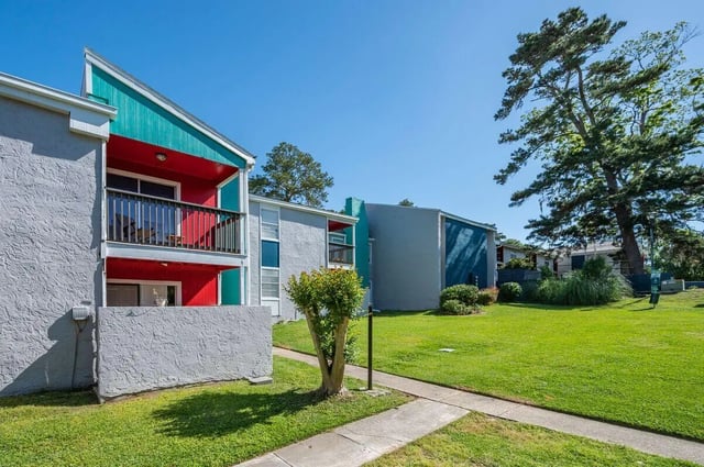 Apartment building exterior with balconies and green lawn exterior at Vertex Tallahassee in Tallahassee Student Accommodation