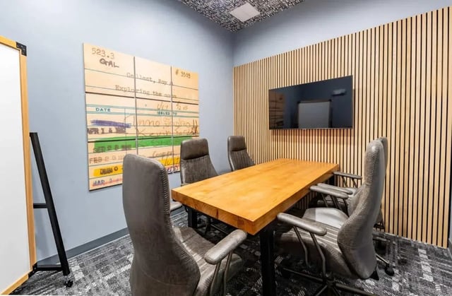 Wooden table and chairs meeting room meeting room at The Annex at Campus West in Tallahassee Student Accommodation