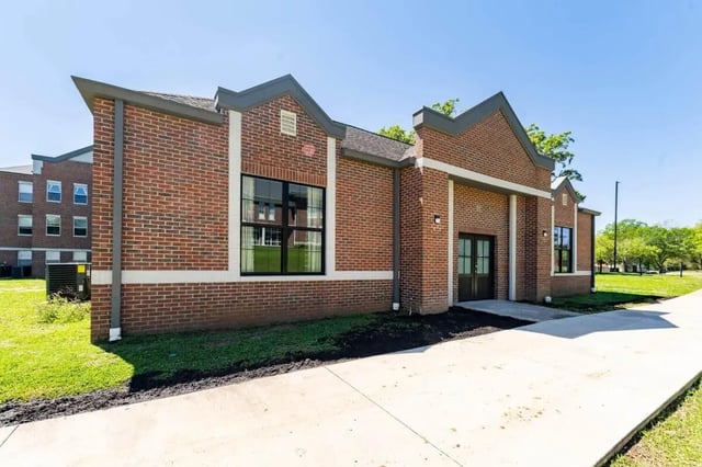 Red brick building with double doors and windows exterior at The Annex at Campus West in Tallahassee Student Accommodation