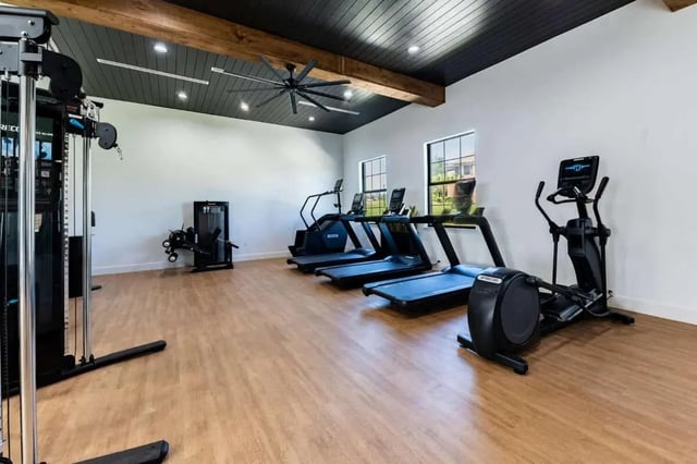 Gym equipment with treadmills elliptical and cable machine gym at The Annex at Campus West in Tallahassee Student Accommodation
