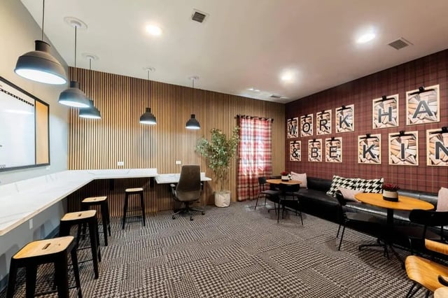 Study area with desks bar stools and seating area lounge at The Annex at Campus West in Tallahassee Student Accommodation