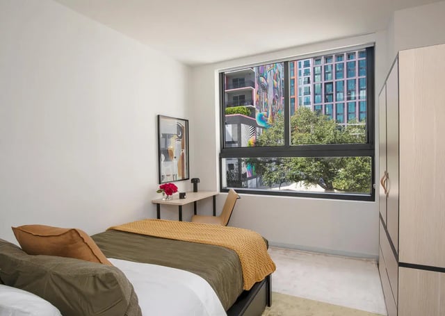 Bed desk artwork closet with window view Bedroom at I5 WYNWOOD in Miami Student Accommodation