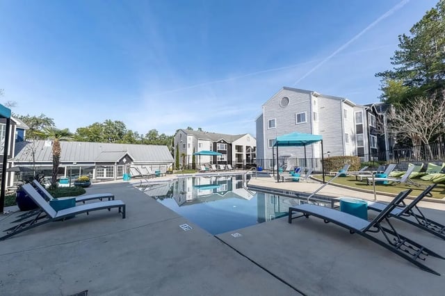Pool lounge chairs and buildings exterior at The Social Seminole in Tallahassee Student Accommodation