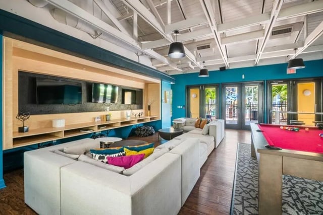 Sofa pool table televisions living room at The Verge Orlando in Orlando Student Accommodation