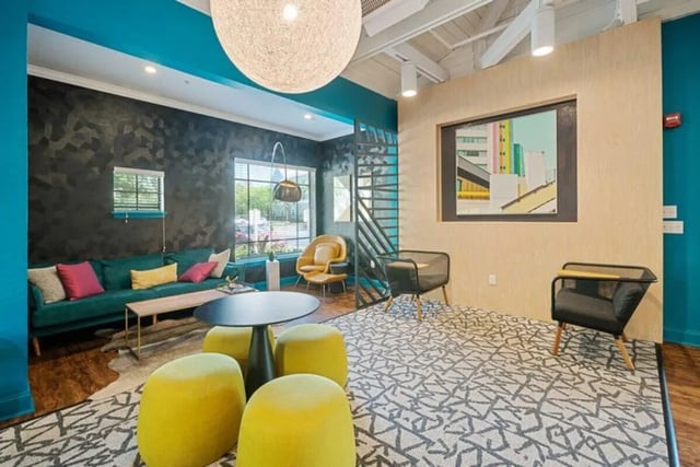 Sofa stools table chairs artwork living room at The Verge Orlando in Orlando Student Accommodation