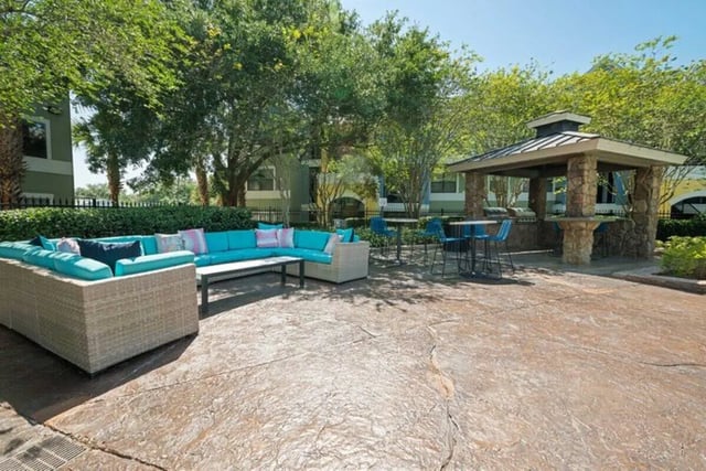 Outdoor lounge area with seating and bar facility at The Verge Orlando in Orlando Student Accommodation