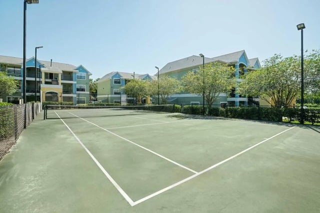 Tennis court with apartments in background playing area at The Verge Orlando in Orlando Student Accommodation