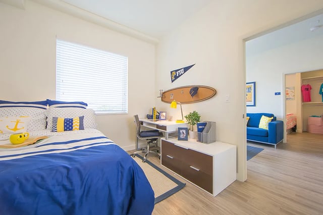 Bed desk chair dresser and surfboard bedroom at Bayview Miami in Miami Student Accommodation