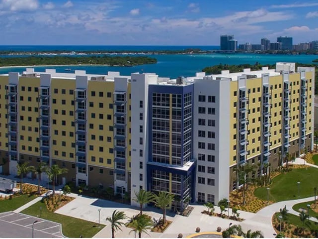 Modern yellow and blue apartment building exterior at Bayview Miami in Miami Student Accommodation