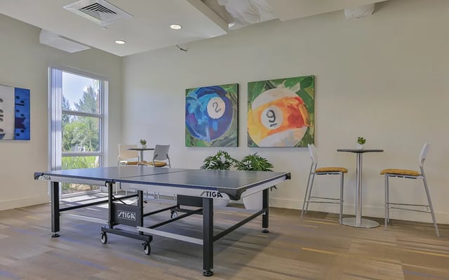 Ping pong table high chairs and paintings playing area at Bayview Miami in Miami Student Accommodation