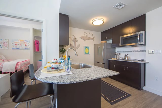 Kitchen with island and visible bedroom kitchen at Bayview Miami in Miami Student Accommodation