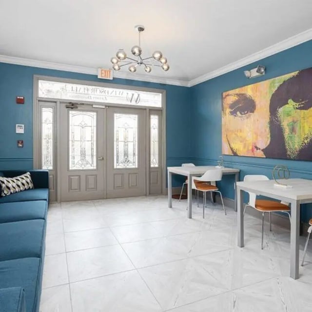Blue couch tables and chairs in common area at Windsor Hall in Gainesville Student Accommodation