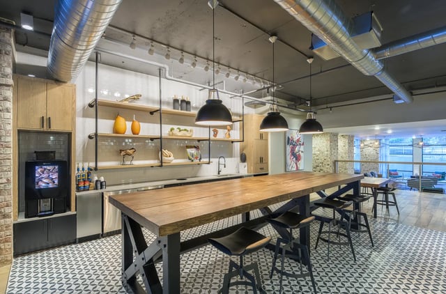 Coffee station, shelving, long table, stools, communal kitchen at The Metropolitan Tallahassee in Tallahassee Student Accommodation