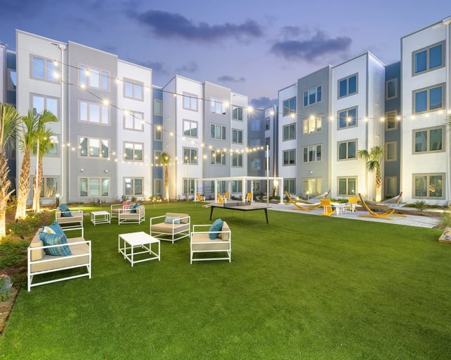Courtyard with seating hammocks and string lights exterior at The Metropolitan Tallahassee in Tallahassee Student Accommodation