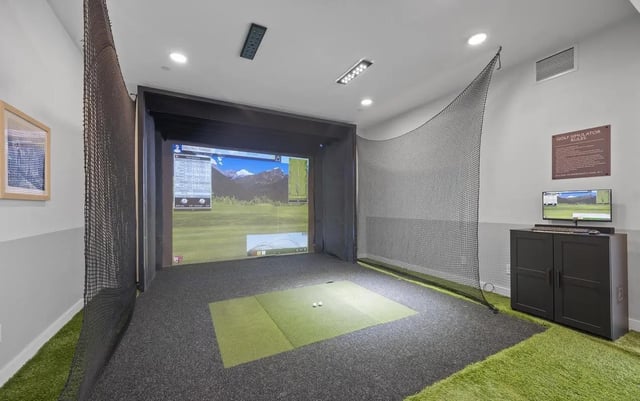 Golf simulator screen golf balls black cabinet gaming area at Stadium House Gainesville in Gainesville Student Accommodation