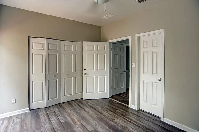 Closet doors open hallway leading to other rooms Bedroom at The Premier Townhomes at 1694 in Tallahassee Student Accommodation