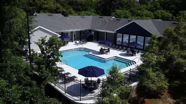 Pool with lounge chairs umbrellas and tables exterior at Boulevard Tallahassee in Tallahassee Student Accommodation