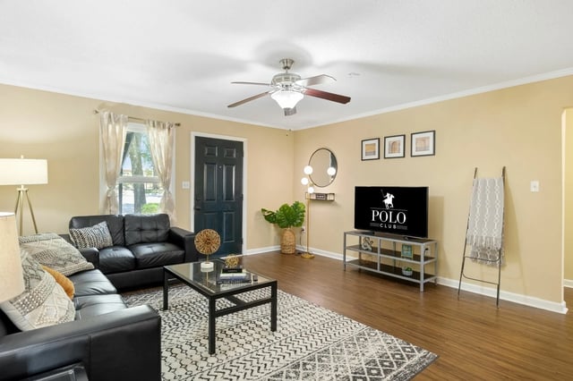 Black sectional sofa coffee table television living room at Polo Club Tallahassee in Tallahassee Student Accommodation