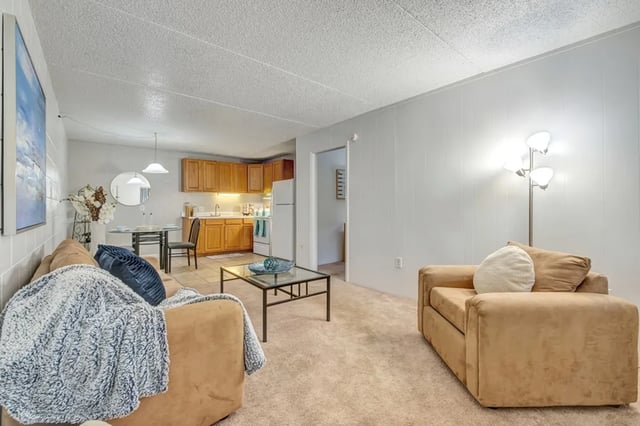 Sofa kitchen dining area and armchair living room at Campus Walk Tallahassee in Tallahassee Student Accommodation