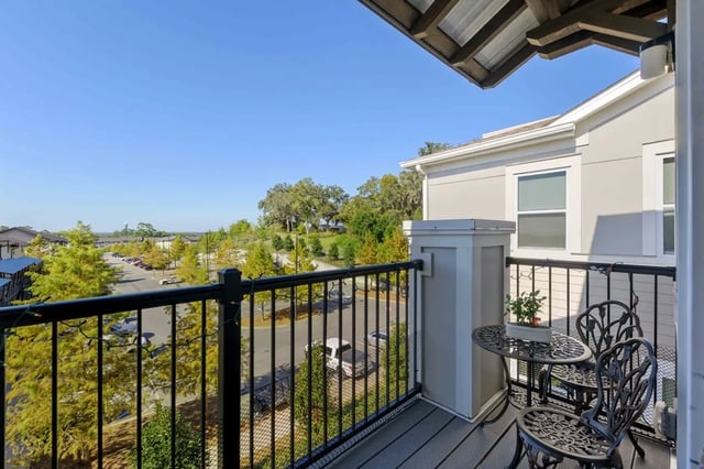Balcony with table chairs and plant exterior at Oktiv in Tallahassee Student Accommodation