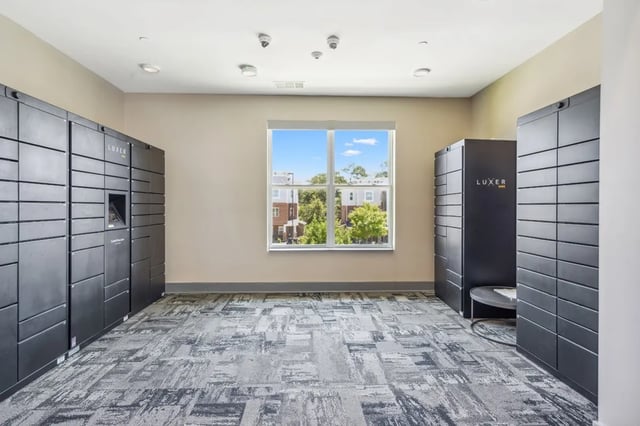 Package lockers large windows modern carpet lobby at Oktiv in Tallahassee Student Accommodation