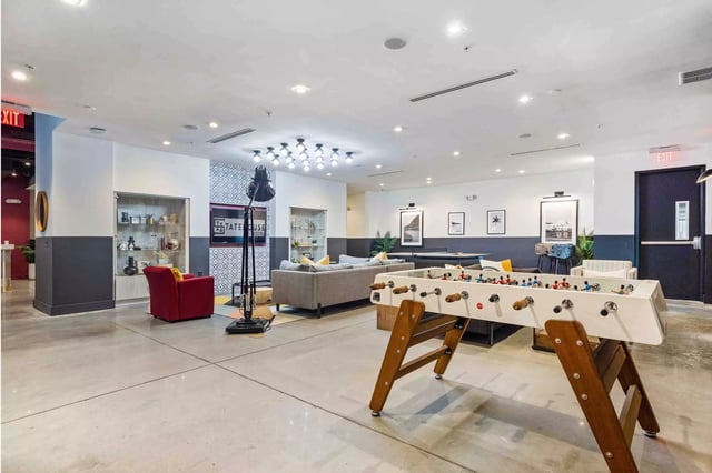 Foosball table couches and display cases Common area at Statehouse Tallahassee in Tallahassee Student Accommodation