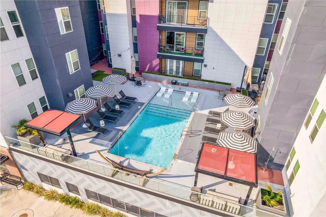 Pool lounge chairs umbrellas and hammock exterior at Statehouse Tallahassee in Tallahassee Student Accommodation