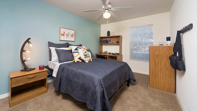 Bed nightstand desk wall rack dresser bedroom at The Crossing at Sante Fe in Gainesville Student Accommodation