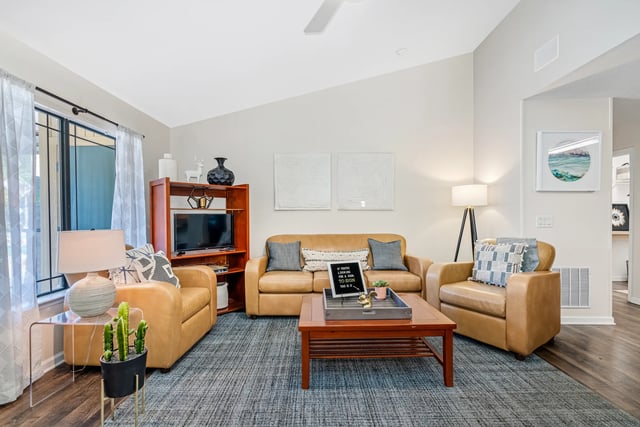 Leather sofas chairs coffee table and rug living room at Forest Lake in Lutz Student Accommodation