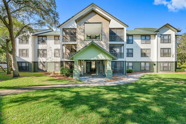 Apartment building with balconies and grass exterior at Forest Lake in Lutz Student Accommodation