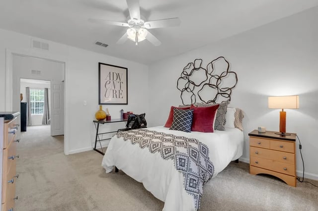 Bed with patterned runner and desk bedroom at The Preserve at San Luis in Tallahassee Student Accommodation