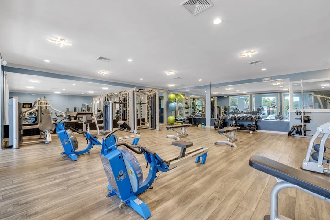 Rowing machines weight racks benches gym interior at The Preserve at San Luis in Tallahassee Student Accommodation