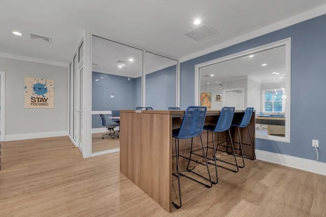 Bar and chairs with glass meeting room study area at The Preserve at San Luis in Tallahassee Student Accommodation