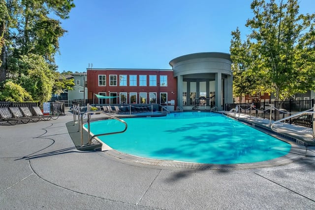 Large blue swimming pool with lounge chairs exterior at The Preserve at San Luis in Tallahassee Student Accommodation