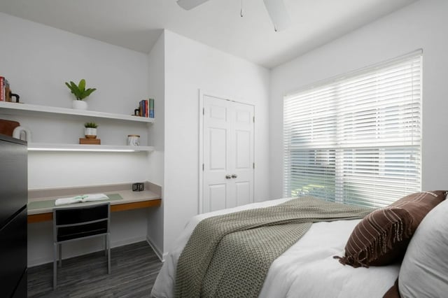 Bed study desk and shelves bedroom at Gainesville Place in Gainesville Student Accommodation