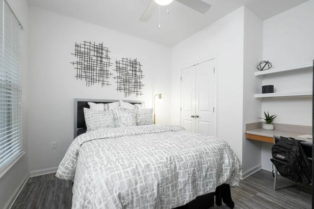 Bed with art work and desk Bedroom at Gainesville Place in Gainesville Student Accommodation