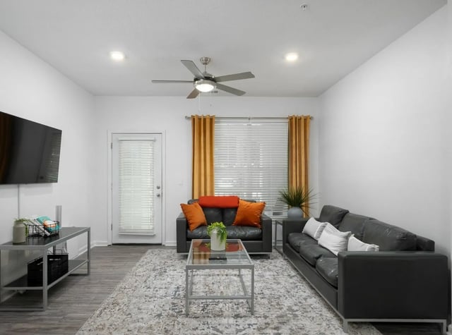Two sofas television and coffee table living room at Gainesville Place in Gainesville Student Accommodation