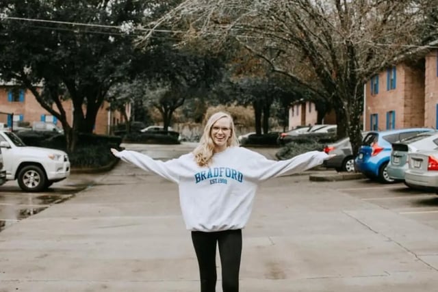Woman smiling in parking lot exterior at Bradford Oaks in Tallahassee Student Accommodation